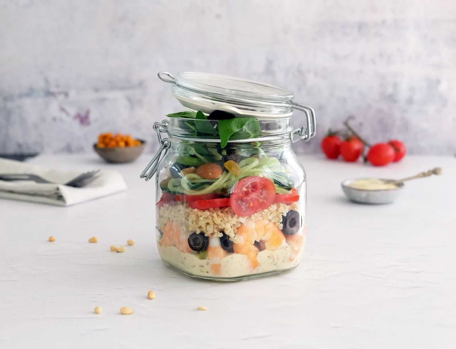 Fresh layered salad sealed in a lidded jar, ready to grab and go